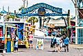 Destin, USA - April 24, 2018: Sign for Harborwalk Village in Emerald Grande Coast in Florida Panhandle with people walking and shopping,