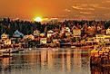 Lobster boats at anchor and bay front homes, Stonington, Maine at sunset