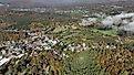 Aerial view of Shelburne, Vermont, surrounded by vibrant fall foliage.