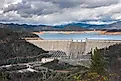 Shasta Dam is a concrete arch-gravity dam across the Sacramento River in Northern California