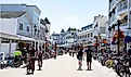 Tourists walking and bicycling on main street in Mackinac Island. Editorial credit: Cavan-Images / Shutterstock.com