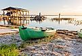 Beautiful lake sunrise with kayak on doc and fisherman in the distance in Mount Dora. Editorial credit: Cavan-Images / Shutterstock.com