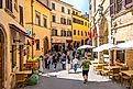 Tourists exploring the streets of Montepulciano, Italy. Image credit: vivooo / Shutterstock.com