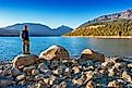 Hiker looks at view at Wallowa Lake and Wallowa Mountains near Joseph, Oregon. 
