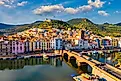 Aerial view of Bosa, Sardinia, with colored houses and a medieval castle.