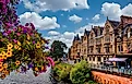 Victorian-era buildings line a busy street in Inverness, Scotland, where locals and tourists stroll amid shops. 