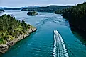 Boat in the ocean among islands. Deception Pass State Park near Anacortes WA.