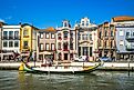 Boat on Canal and Art Nouveau, Novo, buildings in Aveiro in Portugal. (Editorial credit: Richie Chan / Shutterstock.com)