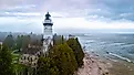 Aerial image of Cana Island Lighthouse in Wisconsin captured on a foggy day along Lake Michigan shoreline. Image by Photo Spirit via Shutterstock. 