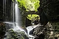 Rainbow Falls with a lady on bridge at Watkins Glen State Park