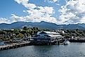 View of city and Olympic Mountains under bright summer cloudscape from ferry in Port Angeles, Washington. Editorial credit: Francisco Blanco / Shutterstock.com