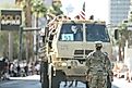  A female soldier of the US Army standing in front of a truck in the Veteran’s Day Parade. Editorial credit: RYO Alexandre / Shutterstock.com
