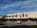 Street view of adobe storefronts in Taos, New Mexico.