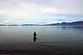 A fisherman fishing in Pyramid Lake which is a large natural lake and a world-class fishery in Nevada. Pyramid Lake, Nevada, United States Editorial credit: Daniel L. Locke / Shutterstock.com