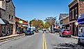 York, South Carolina: Wide angle view down North Congress Street on a sunny, blue sky, spring day. Woman crossing street.