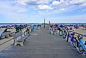 View of the boardwalk along the beach in Ocean Grove, a town on the New Jersey Shore, known for its historic Victorian houses. Editorial credit: EQRoy / Shutterstock.com