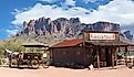 Old Wild West Cowboy town with horse drawn carriage and mountains.