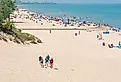 Beach scene on a sunny day at Indiana Dunes State Beach, Lake Michigan. Image credit HPK Images via Shutterstock