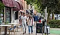 People walking on sidewalk in downtown Saratoga Springs, New York, via aimintang / iStock.com