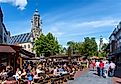 Middelburg’s historic city center with outdoor terraces, the town hall, and the Lange Jan tower. Editorial credit: www.hollandfoto.net / Shutterstock.com