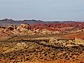 Road running through the otherworldly multicoloured, barren landscape of the Valley of Fire State Park, Nevada. 