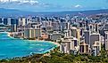 Skyline of Honolulu city as seen from Diamond Head State Monument lookout, with Waikiki beach landscape and ocean views.