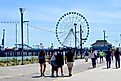 People walking in groups along the Atlantic City Boardwalk, NJ. Editorial credit: edwarda28 / Shutterstock.com