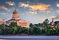 Jefferson City, Missouri, USA downtown view on the Missouri River with the State Capitol at dusk.