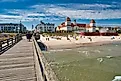 View of the pier with historic building along a sandy beach in Binz, Germany. Image credit: Rico Markus / Shutterstock.com