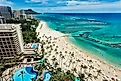 Aereal photo of Waikiki beach with view of Diamond Head mountain in the distance.