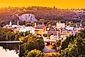 The town skyline of Frankfort, Kentucky, at dusk, with the Kentucky River winding through the scene.