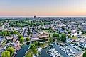 Drone view of Ely Cathedral with Ely Marina and Great Ouse River in foreground, Ely, Cambridgeshire, England.