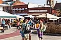 JONESBOROUGH, TN, USA-9/29/18: 3 women talk, while one holds a large pumpkin at Farmers' Market.