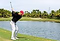 Golfer teeing off a the Trump National Doral. Editorial credit: YES Market Media / Shutterstock.com
