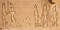 The south wall of the temple of Hathor at Dendera with lion-headed waterspouts. Cleopatra and her son Caesarian (on the left side)