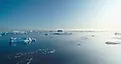 Sunny Antarctica ocean aerial landscape, showcasing ice actively melting. 