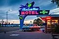 Classic neon sign and vintage Hudson Rambler vehicle at Blue Swallow Motel, a landmark hotel on historic Route 66. Editorial credit: Sandra Foyt / Shutterstock.com