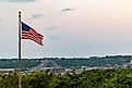 A view of the American flag and Julien Dubuque Bridge against blue sky at sunset in Dubuque city, Iowa, United States