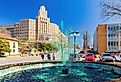 Sunny view of the fountain with green water for St Patrick's Day in Bill Clinton Park, Hot Springs, Arkansas. Image credit Kit Leong via Shutterstock