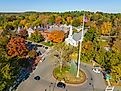 Concord Monument Square aerial view including Holy Family Parish Church and Concord Town Hall in fall with foliage in town center of Concord, Massachusetts MA.