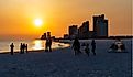 People gathering on the beach to watch the sun set. Gulf Shores is an increasingly popular tourist location. Editorial credit: James.Pintar / Shutterstock.com