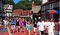 A crowd of people make their way through a recreated Tudor Village in Busch Gardens, in Williamsburg, Virginia. Editorial credit: James Kirkikis / Shutterstock.com