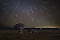 The Geminid Meteor shower taking place above the Very Large Array in New Mexico. Via Shutterstock / Liang Li Photos.
