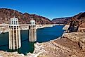 Hoover Dam intake towers in Lake Mead reservoir surrounded by desert canyon walls.