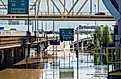 Ohio River waterfront after 7-10 inches of rain fell in a 100 hr period. View down River Rd approaching the entrance ramp to I-64 under the yellow Second Street Bridge. Editorial credit: Mike Worley Photos / Shutterstock.com
