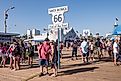 Santa Monica, CA: Crowd of tourists surround the road sign for the end of the famous Route 66 on the Santa Monica Pier in Los Angeles County. Editorial credit: Sandra Foyt / Shutterstock.com