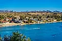 A jet skier speeds by riverfront property on the Colorado River in Bullhead City, Arizona. Image credit: Felipe Sanchez / Shutterstock.com