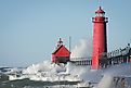 Waves crashing on lighthouse. Grand Haven lighthouse on Lake Michigan. Horizontal format.