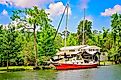 A boat is docked on the Magnolia River near Magnolia Landing in Magnolia Springs, Alabama. Image credit: Carmen K. Sisson / Shutterstock.com.