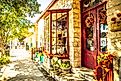 View from the sidewalk, looking at a colorful store adorned with flowers on Main Street in Fredericksburg, Texas, USA, known as "The Magic Mile." Editorial credit: ShengYing Lin / Shutterstock.com